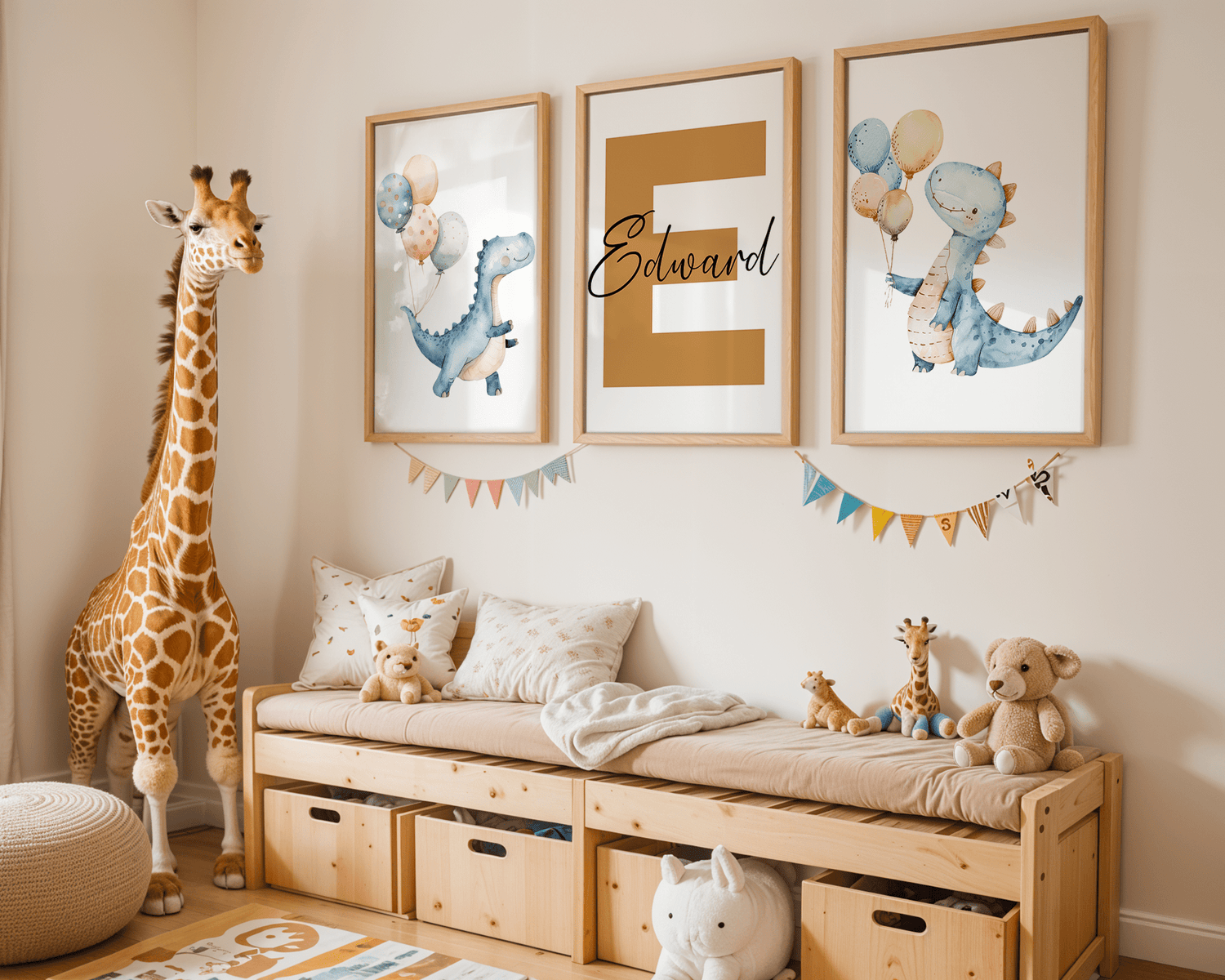 A cozy nursery featuring three framed wall art prints, including playful blue dinosaurs with balloons and a large golden initial with cursive text. The room is decorated with a wooden bench, plush toys, a tall giraffe figure, and colorful bunting