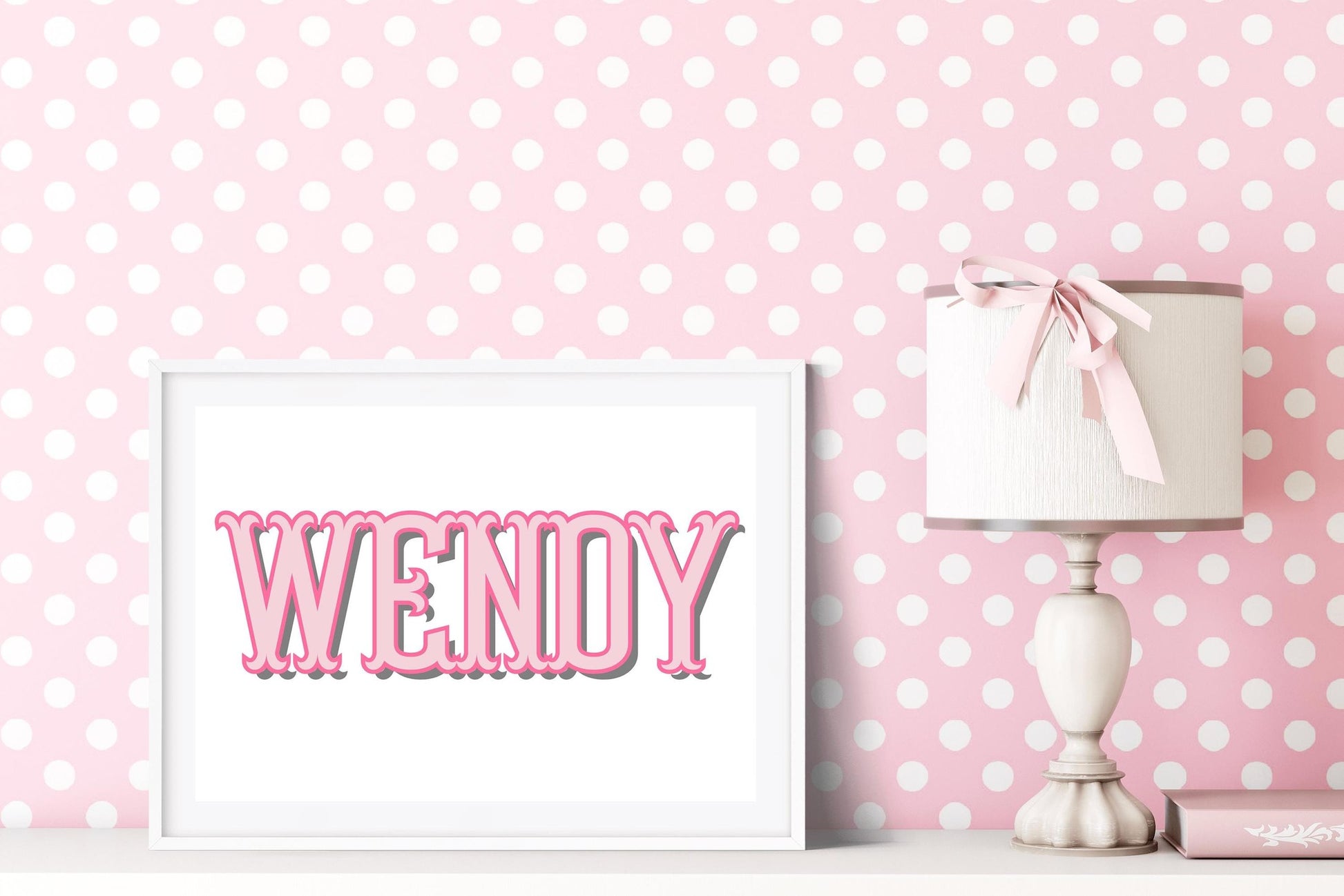 Pink custom baby name sign in a nursery setting with polka dot wallpaper, creating a charming baby nursery decor piece or new baby gift.