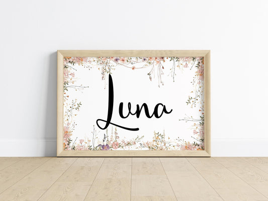 Wooden-framed wildflower nursery name sign with delicate floral accents, designed for above crib signs and custom nursery wall art.