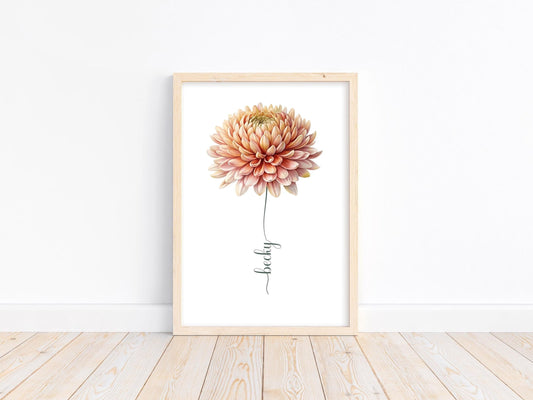 A framed wildflower art print placed on a light wood floor with a white wall backdrop. Perfect for custom nursery decor or baby shower gifts.